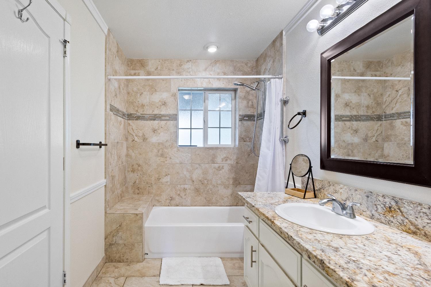 35171 Sand Creek Road Squaw Valley, CA 93675 - Photo 11 of 35 a bathroom with a granite countertop sink a mirror a bathtub and shower