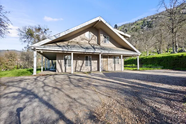 a front view of a house with a garden
