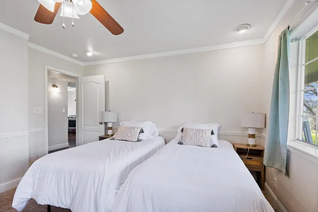 a bedroom with a bed and a large window