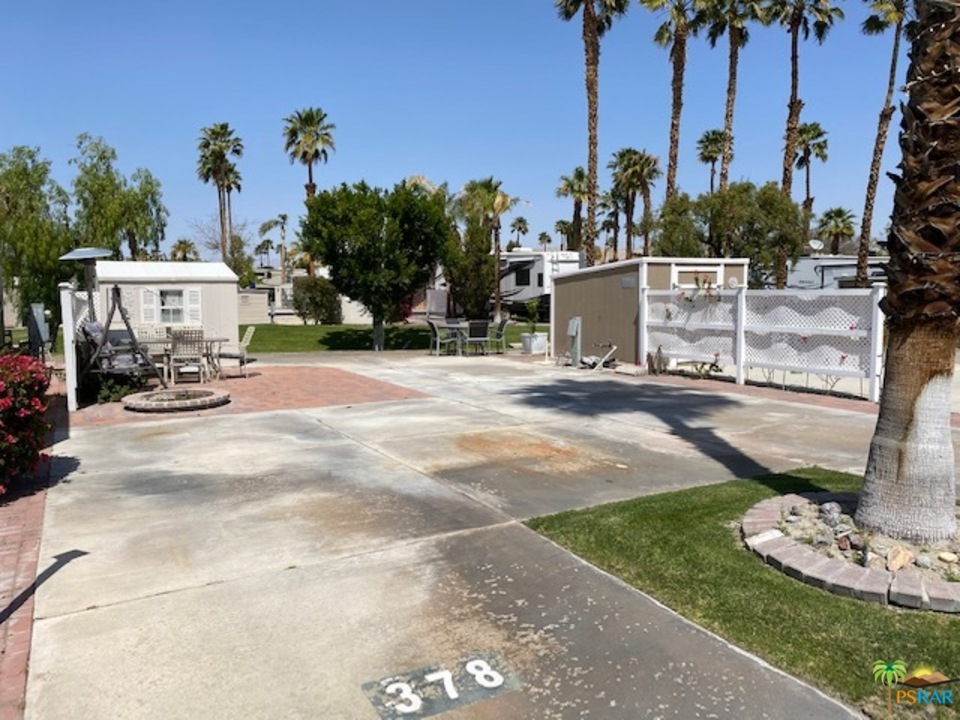 69801 Ramon Road, Unit 378 Cathedral City, CA 92234 - Photo 2 of 5 a view of a backyard with a car parked in it