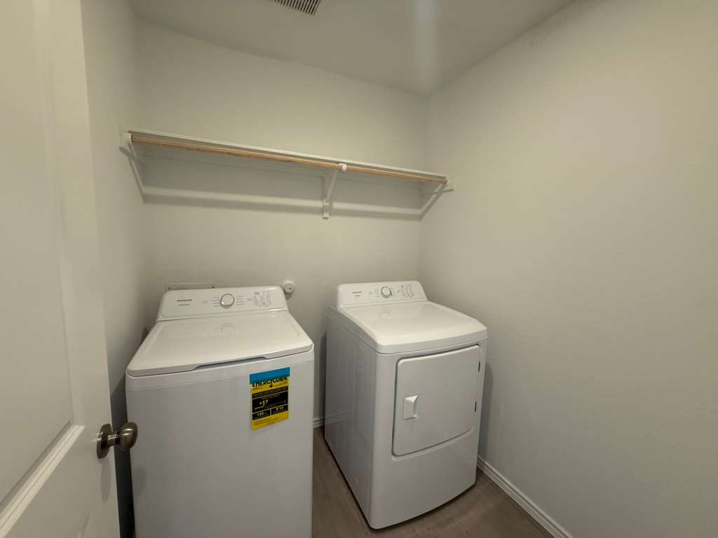 623 Sormonne Loop Kyle, TX 78640 - Photo 14 of 40 Laundry room with separate washer and dryer and baseboards