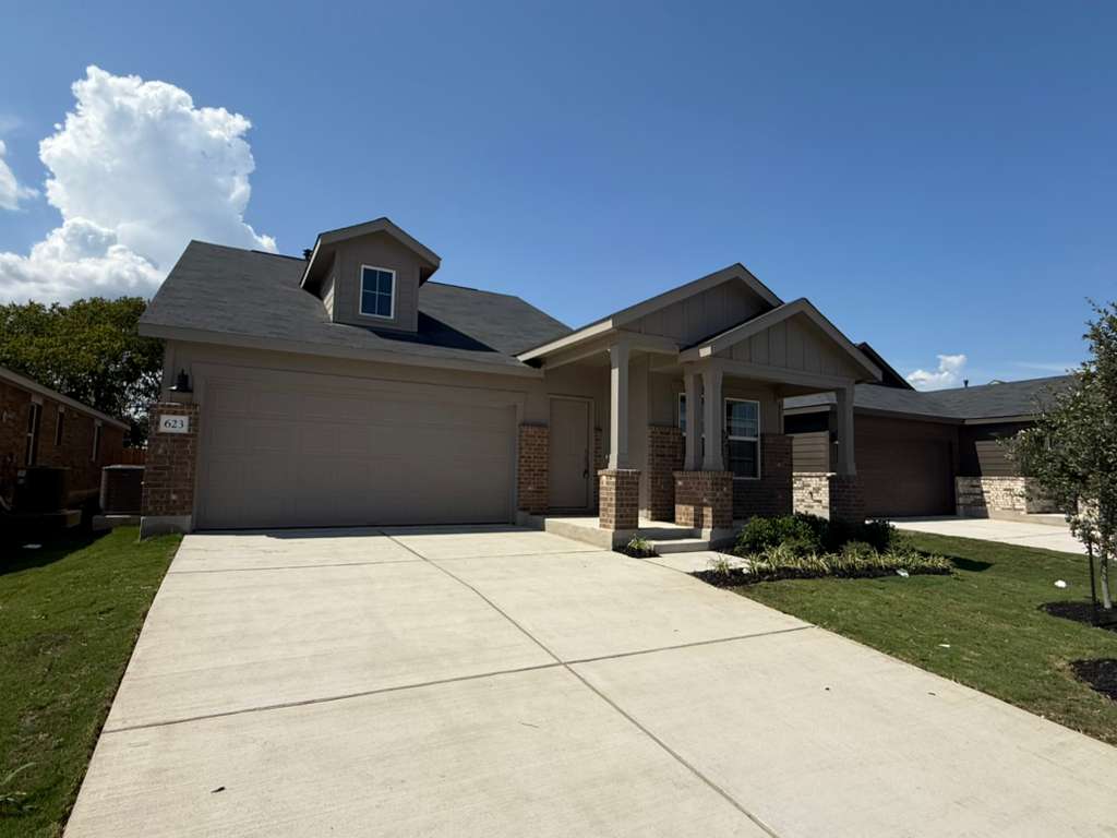 623 Sormonne Loop Kyle, TX 78640 - Photo 2 of 40 View of front facade featuring brick siding, concrete driveway, an attached garage, a front yard, and a porch