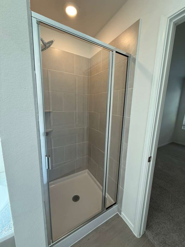 623 Sormonne Loop Kyle, TX 78640 - Photo 28 of 40 Full bathroom with a stall shower and recessed lighting