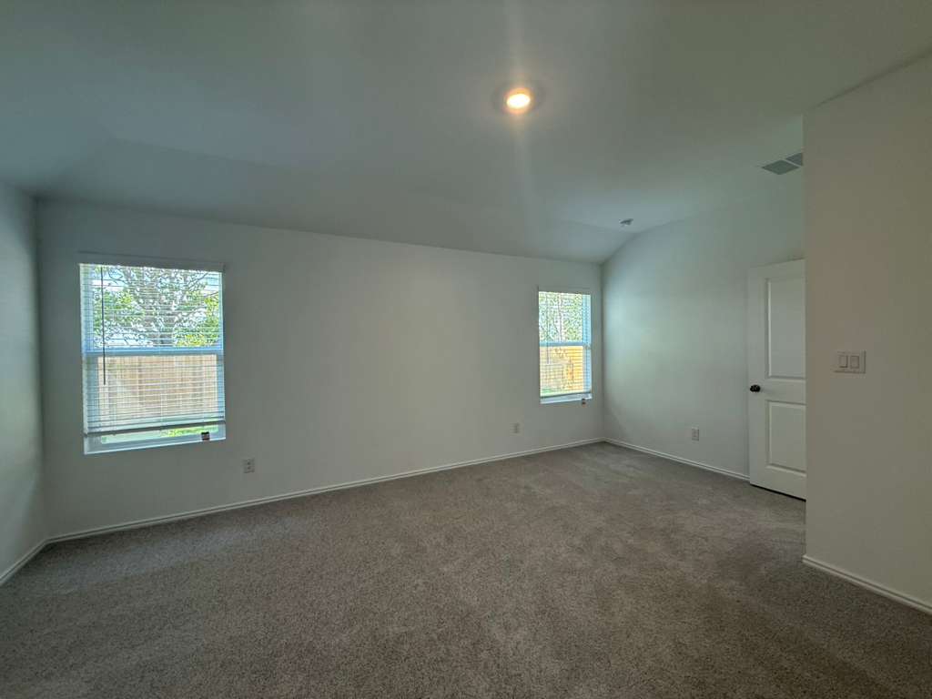 623 Sormonne Loop Kyle, TX 78640 - Photo 29 of 40 Empty room with carpet flooring and baseboards