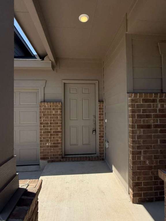 623 Sormonne Loop Kyle, TX 78640 - Photo 4 of 40 Doorway to property featuring brick siding