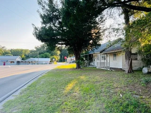 a view of a house with pool and a yard