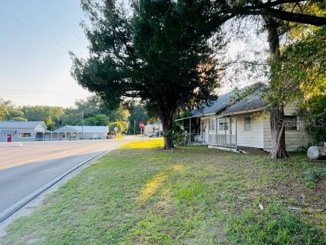 a view of a house with pool and a yard