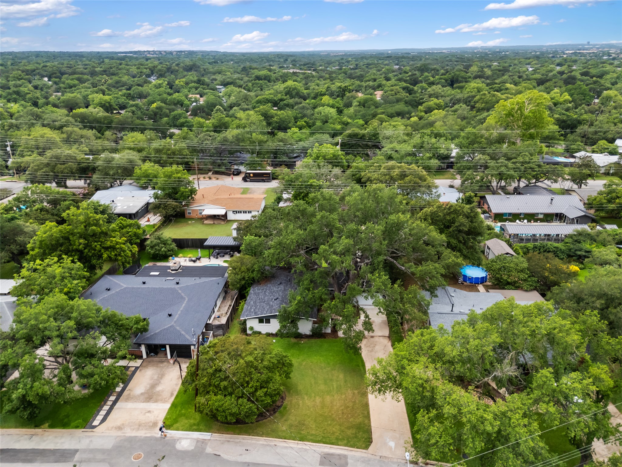 4602 Frontier Trail Austin, TX 78745 - Photo 21 of 21 An aerial perspective reveals a tree-lined neighborhood featuring residential homes with private yards and lush landscaping.