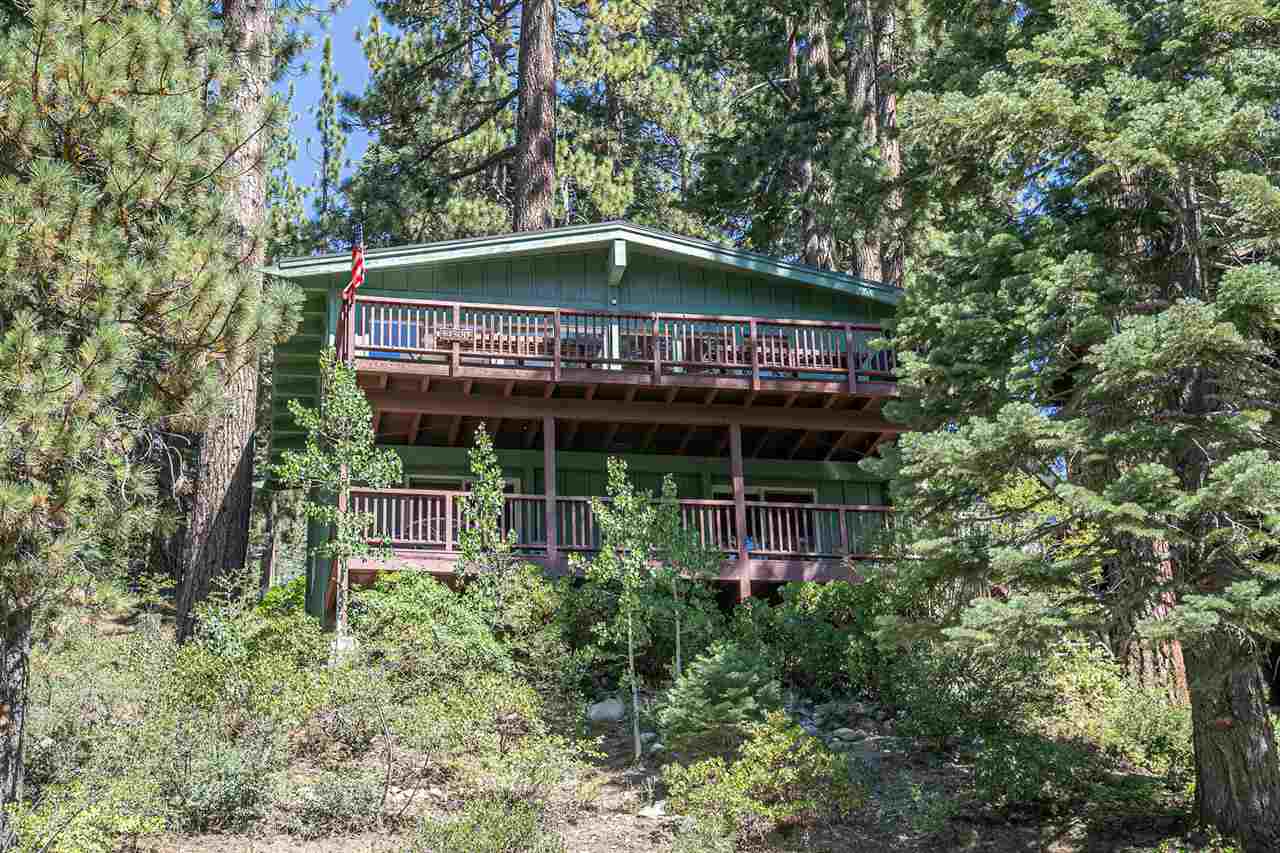 14300 Donner Pass Road Truckee, CA 96161 - Photo 3 of 20 a backyard of a house with table and chairs under an umbrella