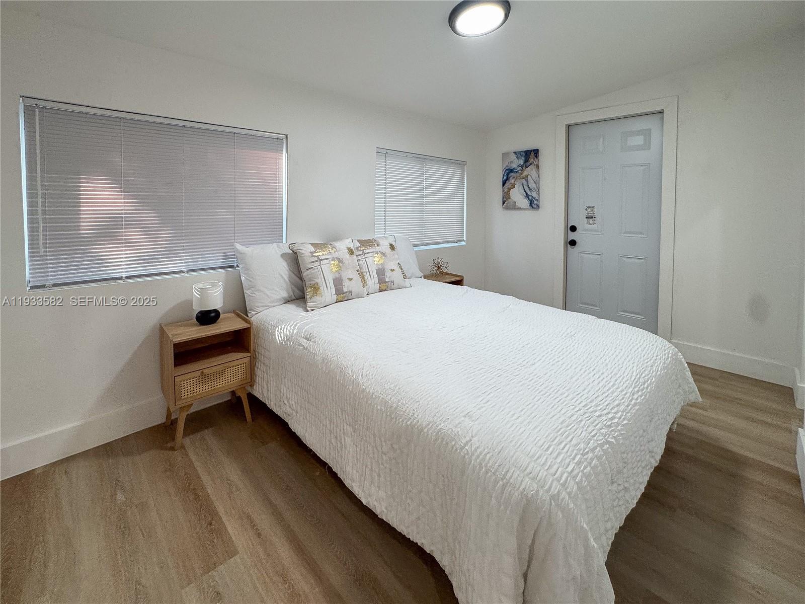 794 Northwest 44th Street Miami, FL 33127 - Photo 18 of 31 a large bed sitting in a bedroom next to a window