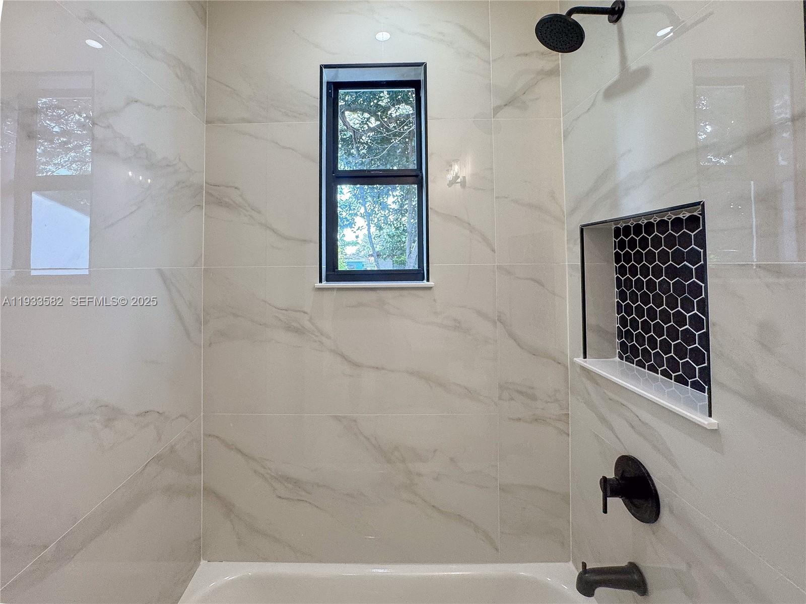 794 Northwest 44th Street Miami, FL 33127 - Photo 20 of 31 a bathroom with a bathtub and shower