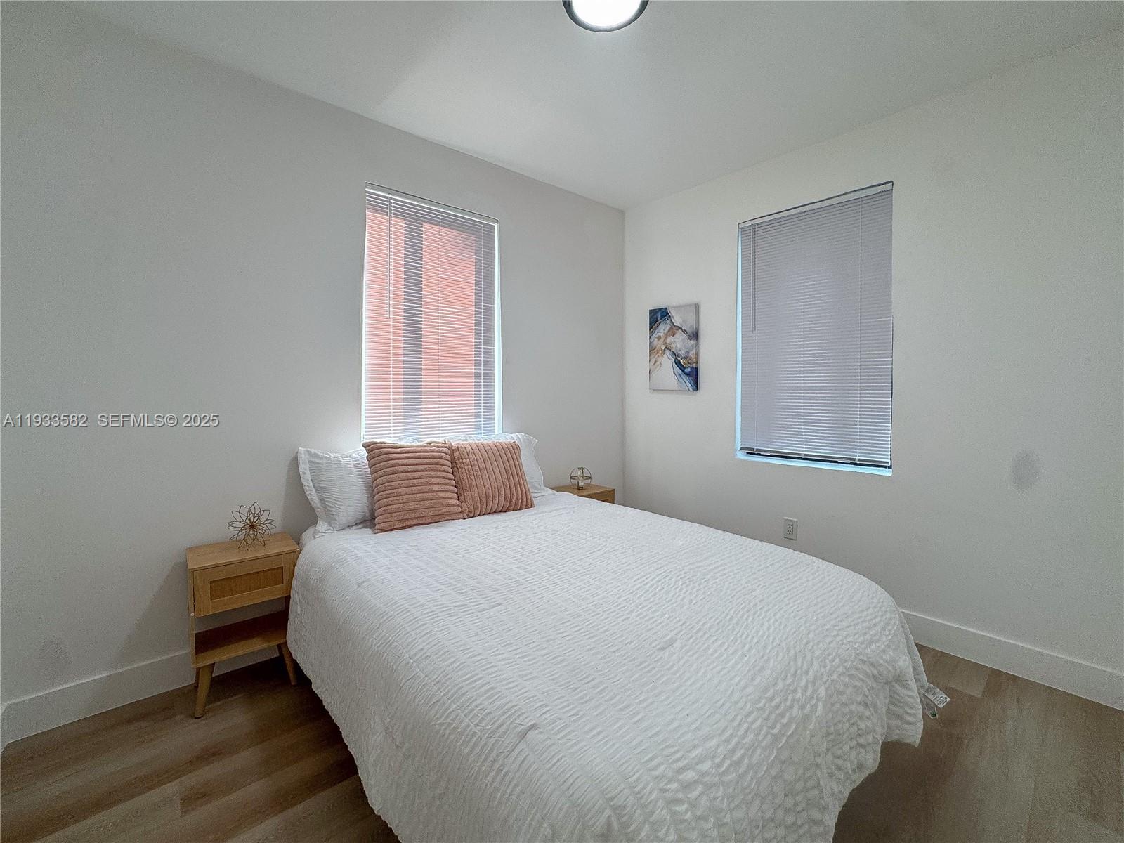 794 Northwest 44th Street Miami, FL 33127 - Photo 21 of 31 a bedroom with a bed and wooden floor