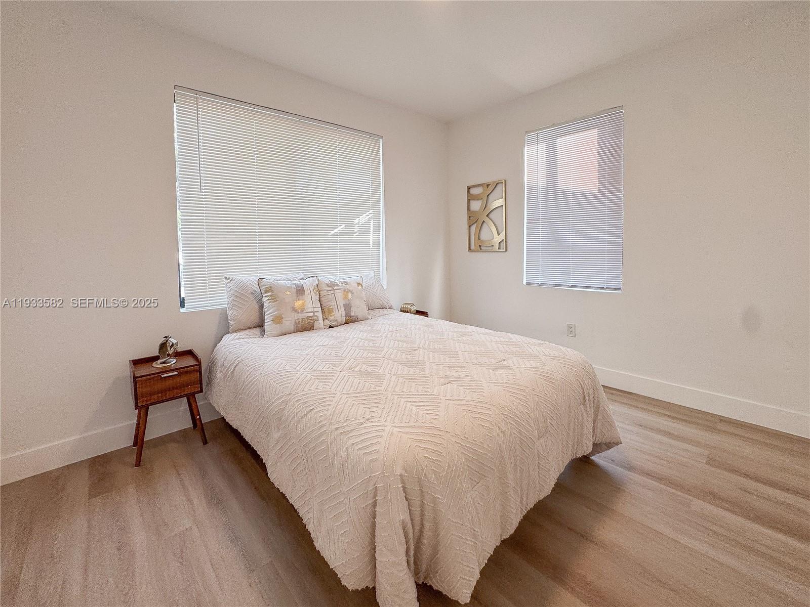 794 Northwest 44th Street Miami, FL 33127 - Photo 22 of 31 a bedroom with a bed and a night stand