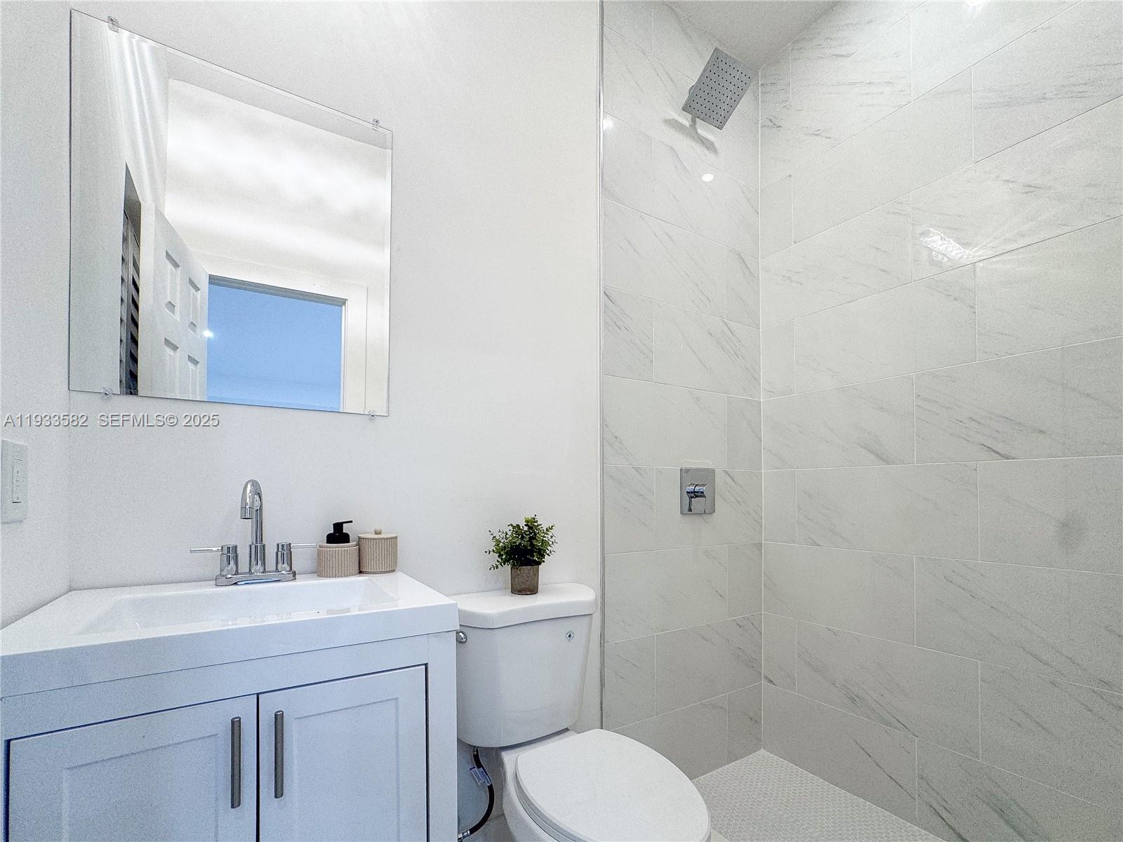 794 Northwest 44th Street Miami, FL 33127 - Photo 23 of 31 a bathroom with a sink toilet and shower