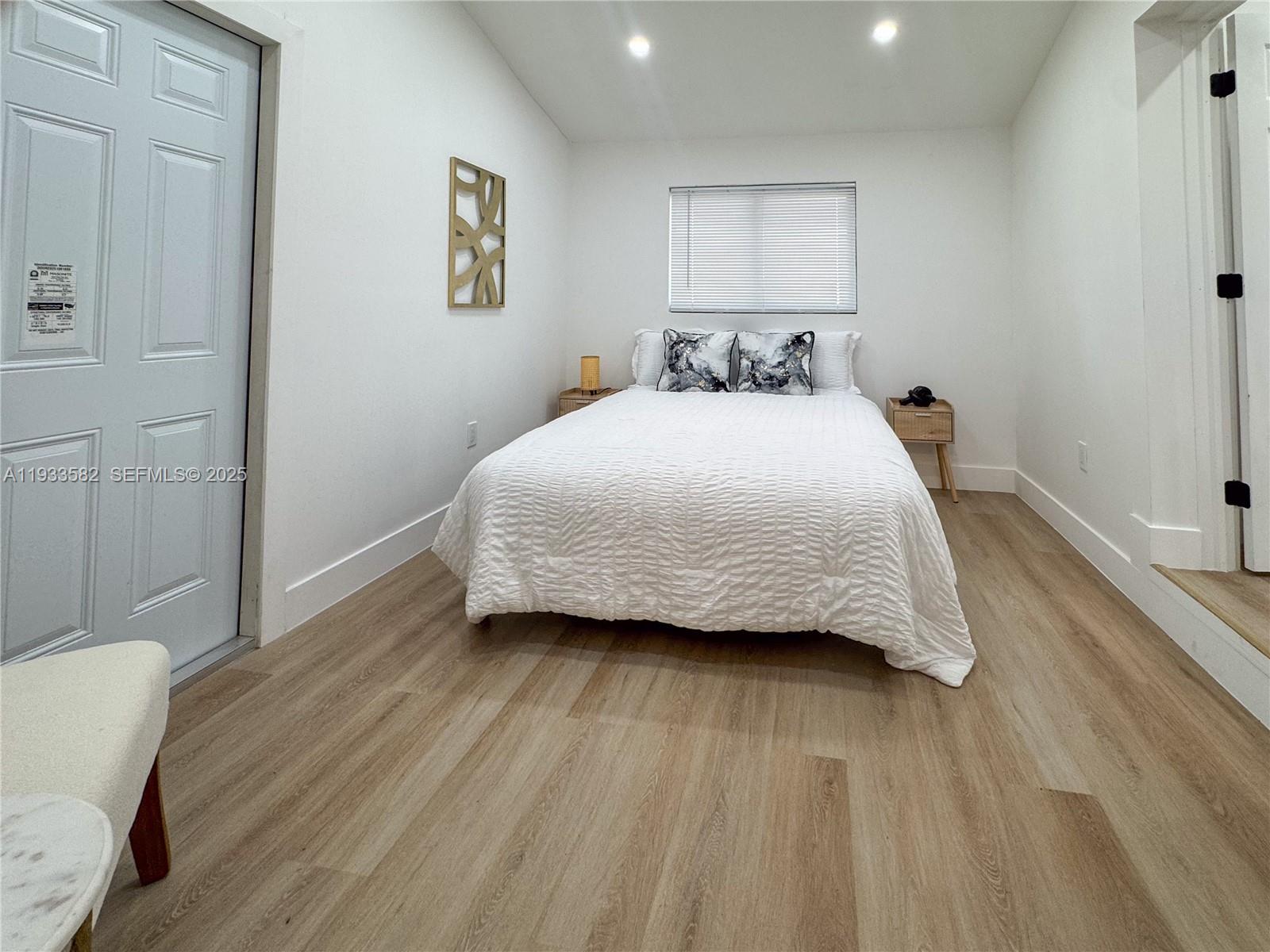 794 Northwest 44th Street Miami, FL 33127 - Photo 26 of 31 a bedroom with a bed and a table