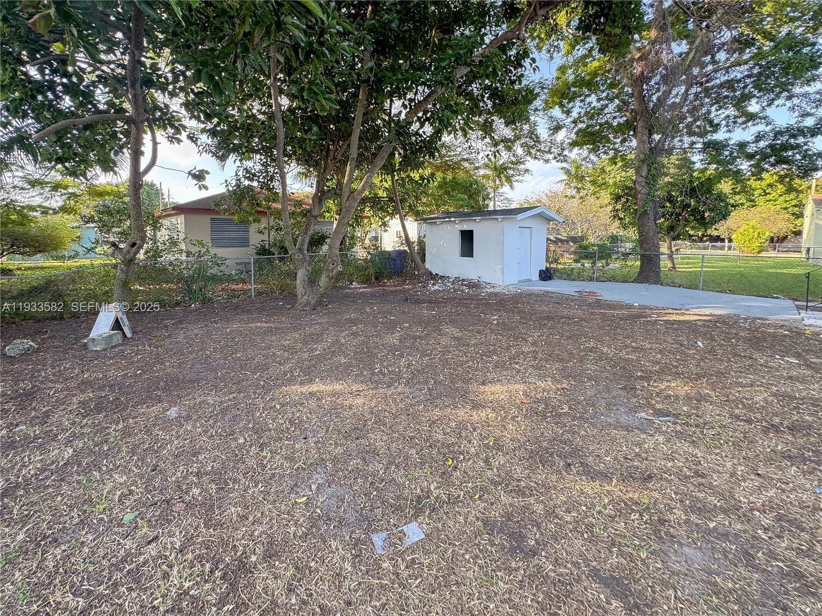 794 Northwest 44th Street Miami, FL 33127 - Photo 27 of 31 a view of a house with a yard and tree s
