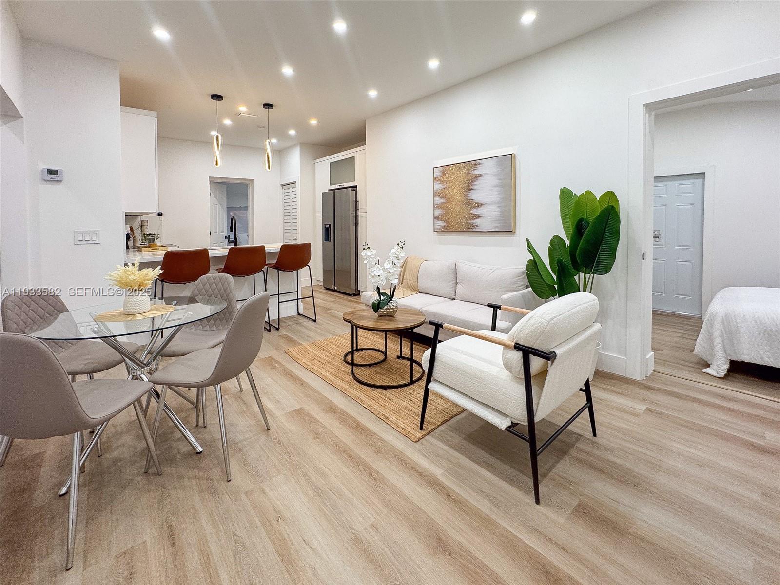 794 Northwest 44th Street Miami, FL 33127 - Photo 7 of 31 a living room with furniture and a potted plant