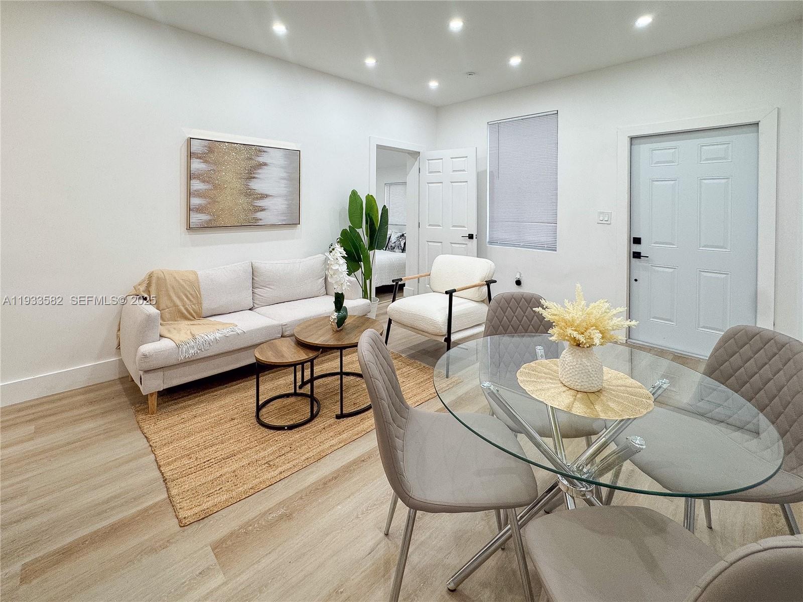 794 Northwest 44th Street Miami, FL 33127 - Photo 8 of 31 a living room with furniture and wooden floor