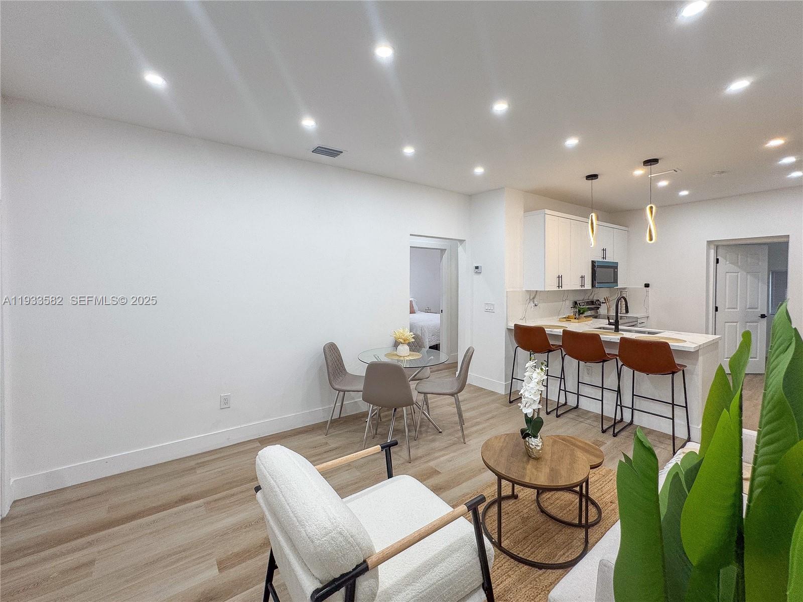 794 Northwest 44th Street Miami, FL 33127 - Photo 9 of 31 a living room with furniture kitchen and a table