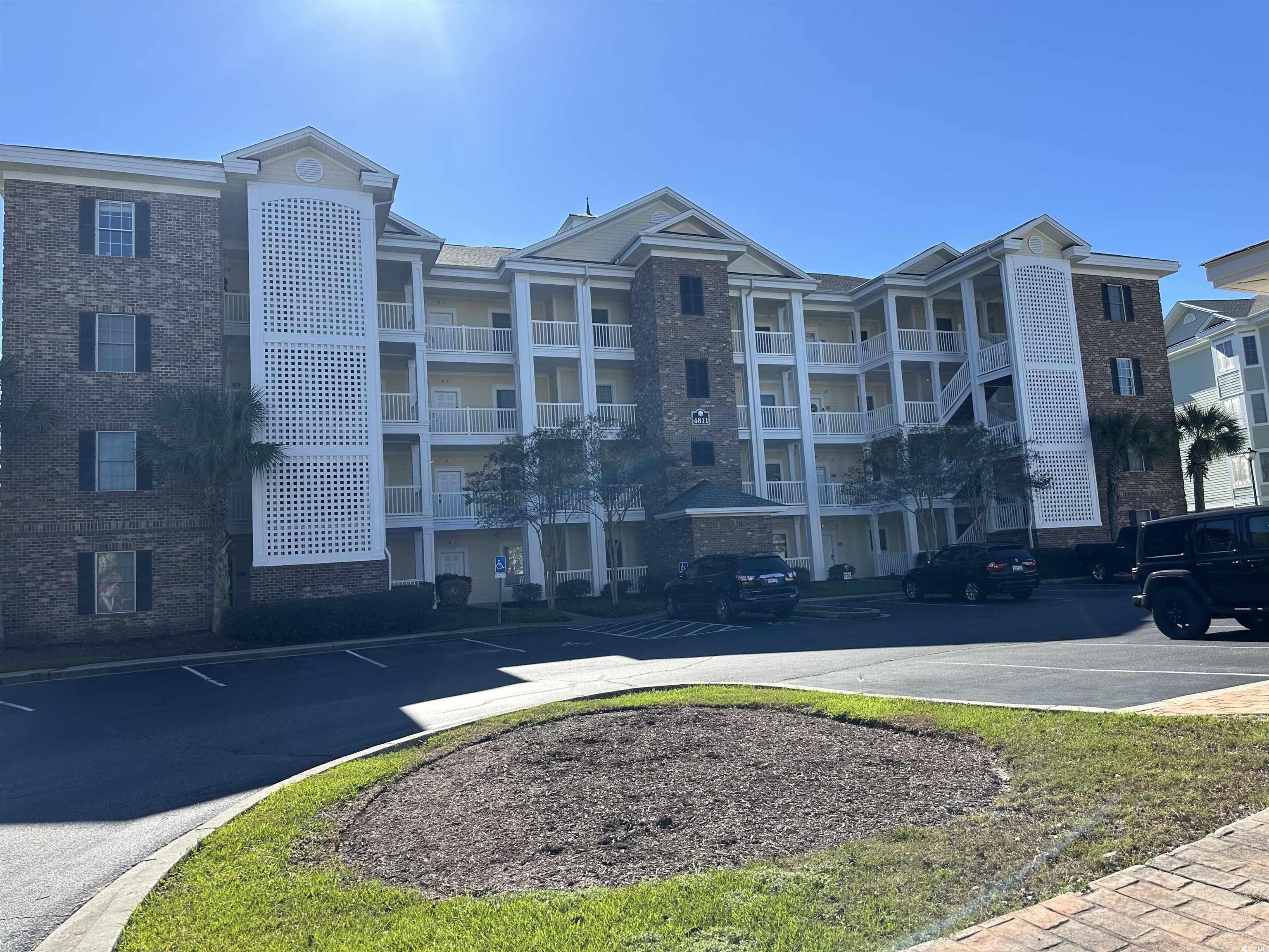 4811 Magnolia Lake Drive, Unit 302 Myrtle Beach, SC 29577 - Photo 1 of 39 View of apartment building / complex with uncovered parking