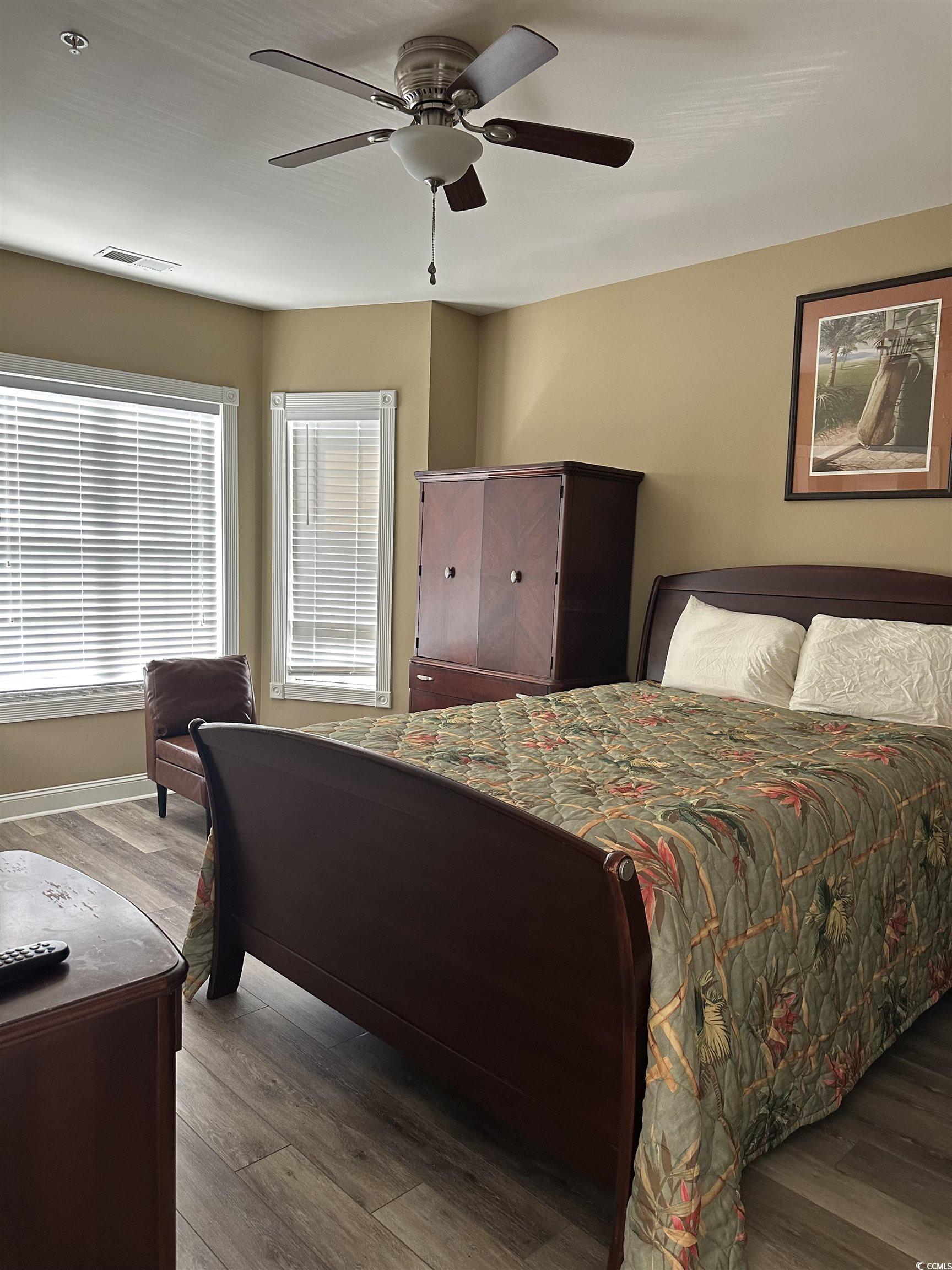 4811 Magnolia Lake Drive, Unit 302 Myrtle Beach, SC 29577 - Photo 12 of 39 Bedroom with wood finished floors and ceiling fan