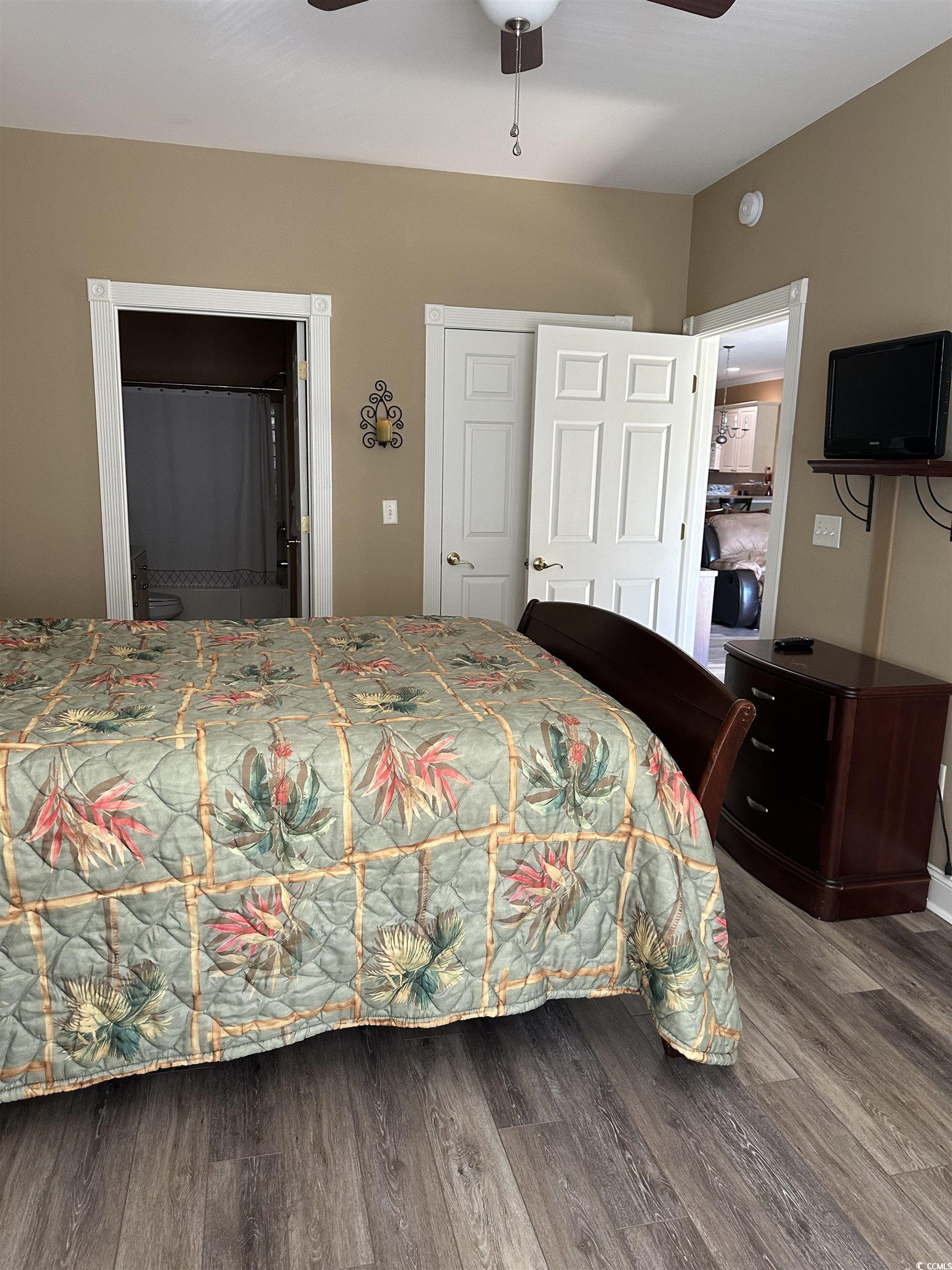 4811 Magnolia Lake Drive, Unit 302 Myrtle Beach, SC 29577 - Photo 13 of 39 Bedroom with a closet, wood finished floors, ceiling fan, and connected bathroom