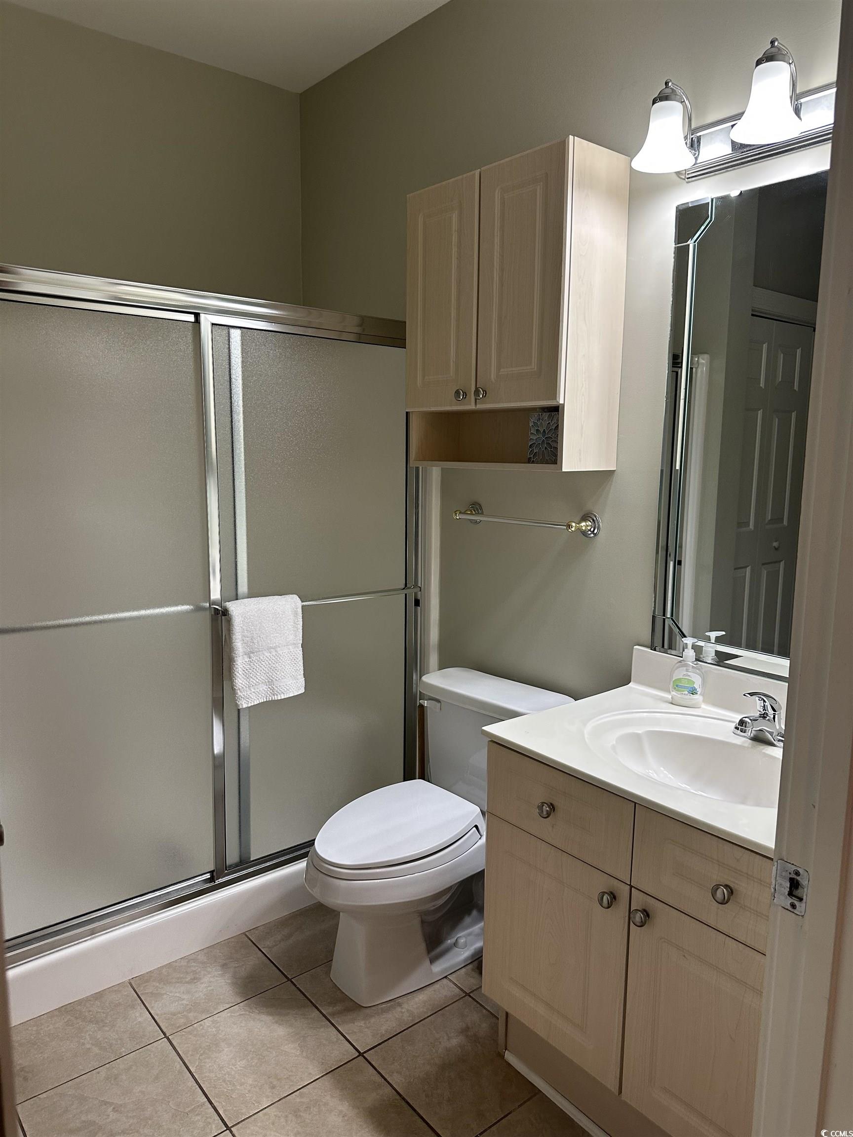 4811 Magnolia Lake Drive, Unit 302 Myrtle Beach, SC 29577 - Photo 14 of 39 Bathroom featuring vanity, a stall shower, and light tile patterned flooring