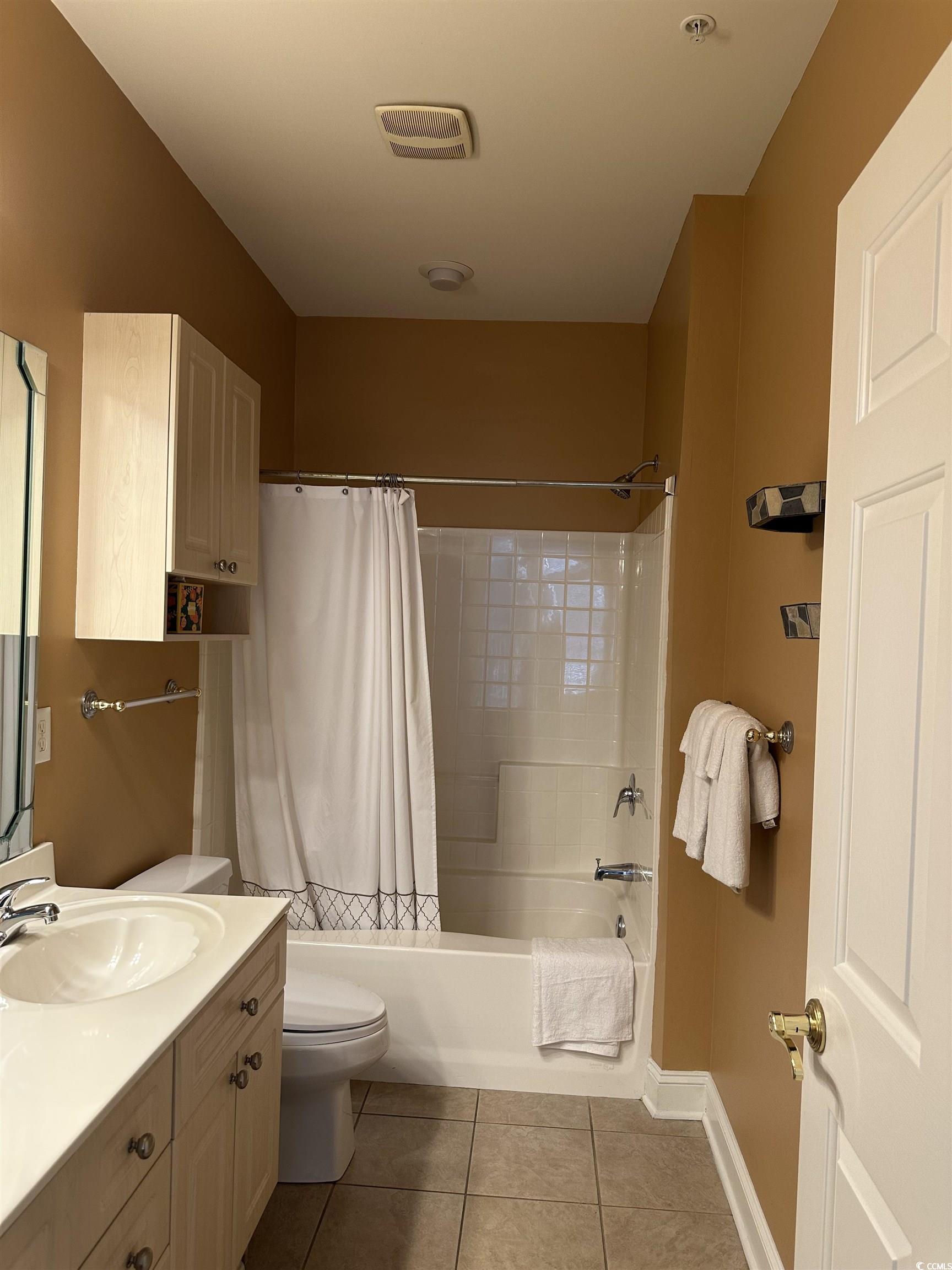 4811 Magnolia Lake Drive, Unit 302 Myrtle Beach, SC 29577 - Photo 17 of 39 Full bath with light tile patterned flooring, vanity, and shower / tub combo