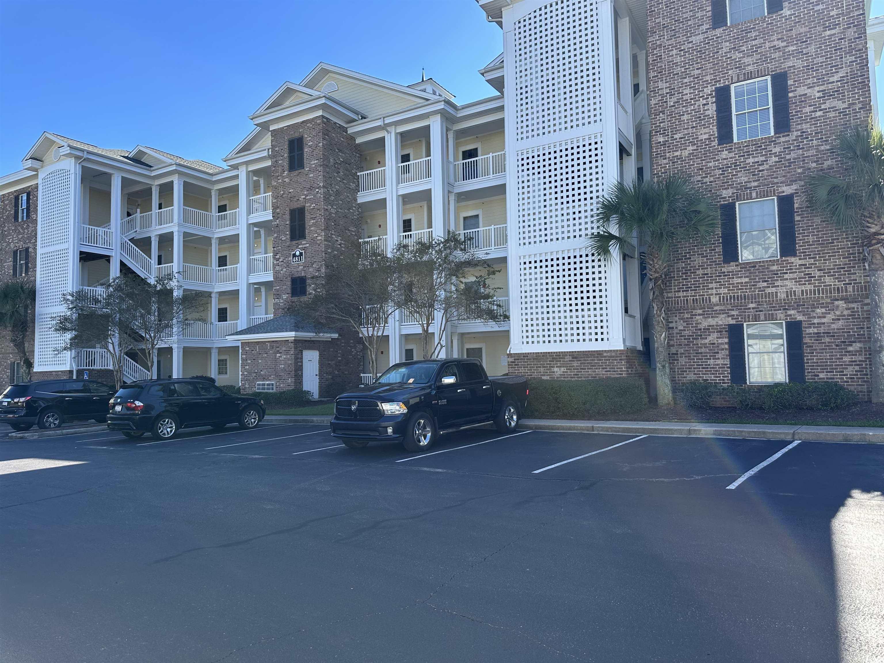 4811 Magnolia Lake Drive, Unit 302 Myrtle Beach, SC 29577 - Photo 2 of 39 View of apartment building / complex featuring uncovered parking