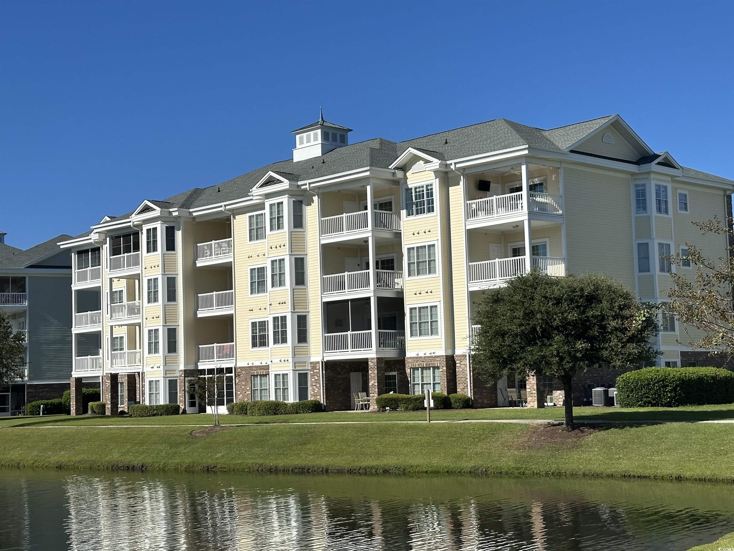 4811 Magnolia Lake Drive, Unit 302 Myrtle Beach, SC 29577 - Photo 32 of 39 View of apartment building / complex with a water view