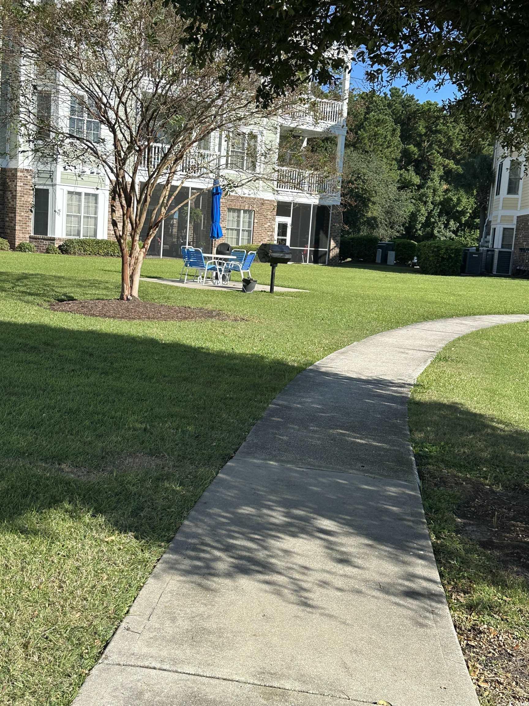 4811 Magnolia Lake Drive, Unit 302 Myrtle Beach, SC 29577 - Photo 33 of 39 View of home's community with a yard