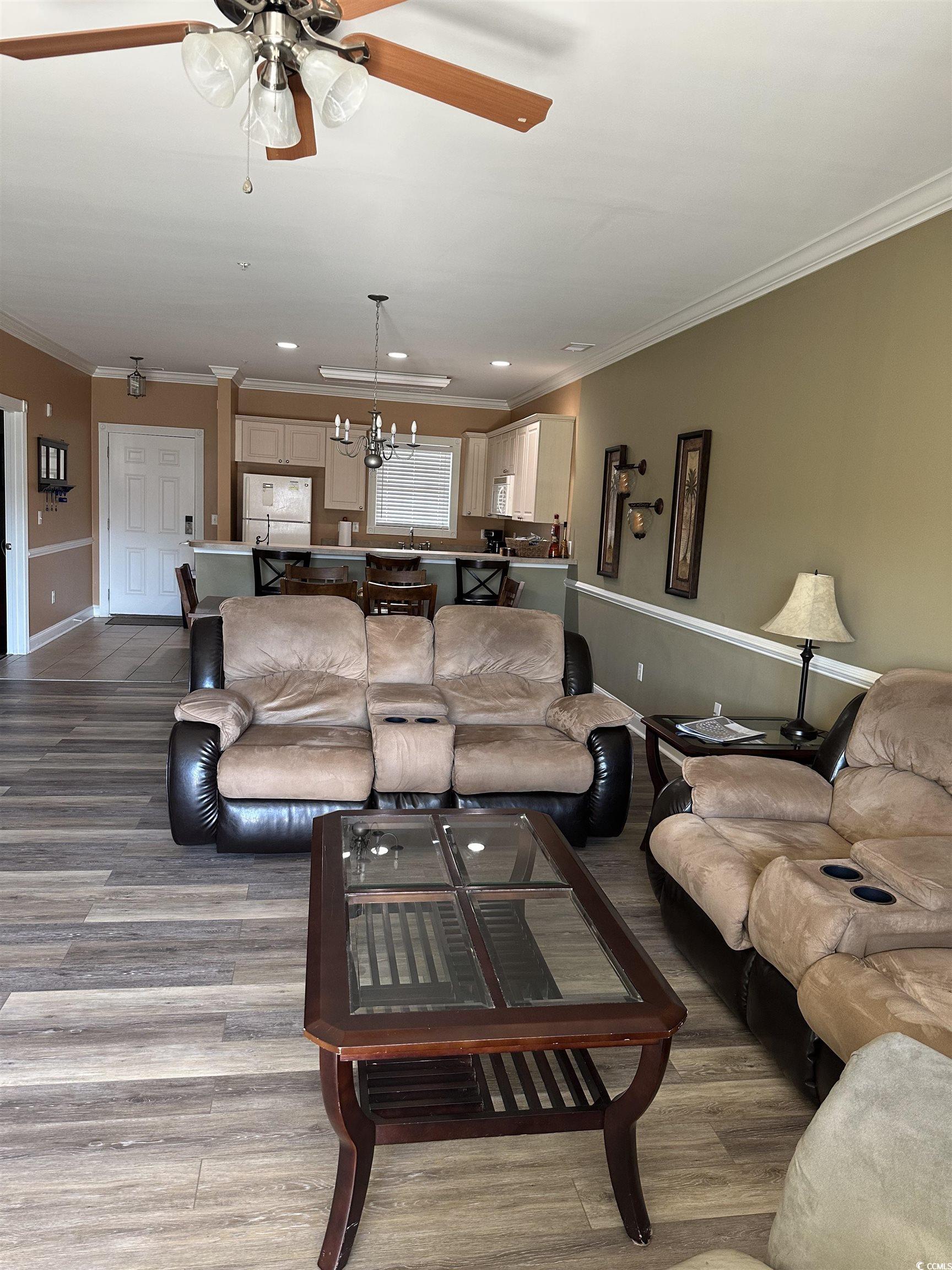 4811 Magnolia Lake Drive, Unit 302 Myrtle Beach, SC 29577 - Photo 6 of 39 Living area with ornamental molding, recessed lighting, a chandelier, light wood finished floors, and a ceiling fan