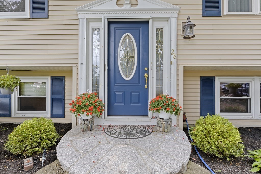28 Edgewood Road Holbrook, MA 02343 - Photo 1 of 29 a front view of a house with lots of potted plants
