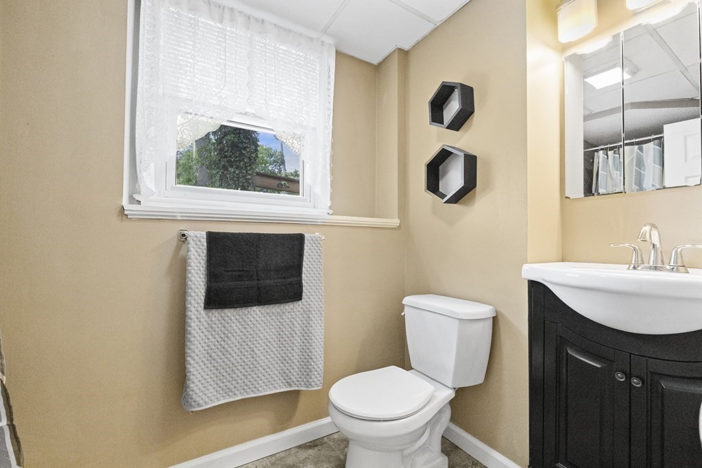 28 Edgewood Road Holbrook, MA 02343 - Photo 20 of 29 a bathroom with a toilet a sink and mirror