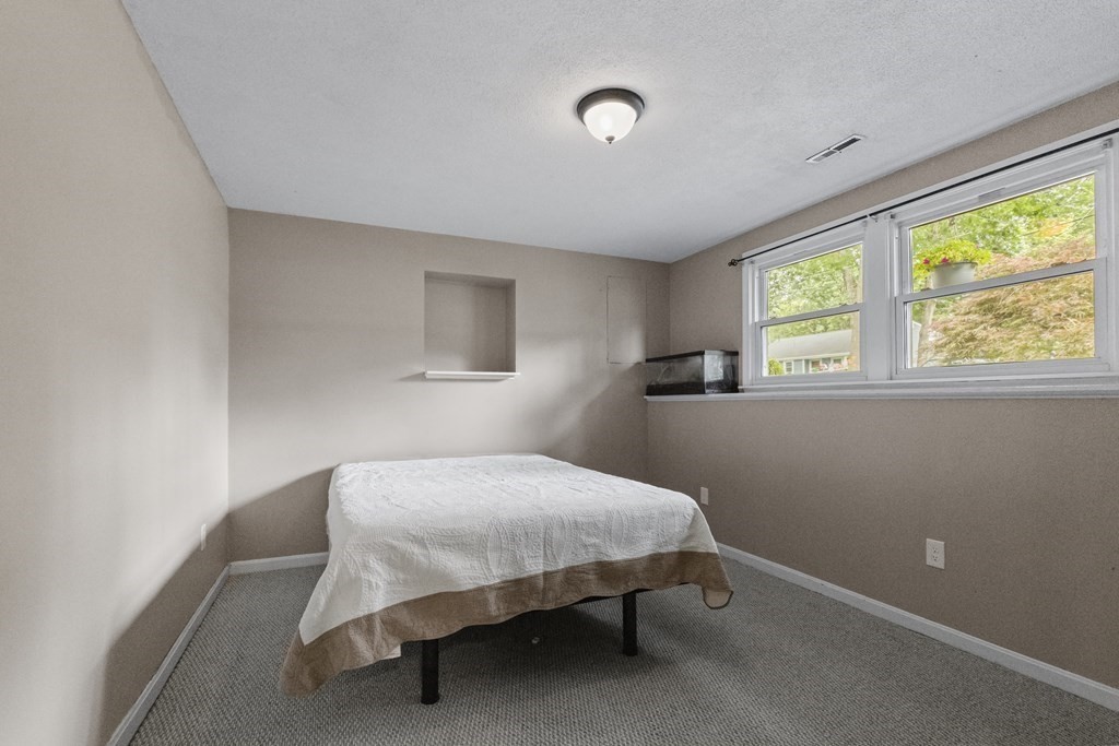 28 Edgewood Road Holbrook, MA 02343 - Photo 21 of 29 a bedroom with a bed and a window