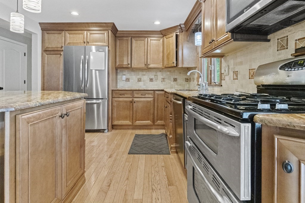 28 Edgewood Road Holbrook, MA 02343 - Photo 5 of 29 a kitchen with a stove a sink and a refrigerator