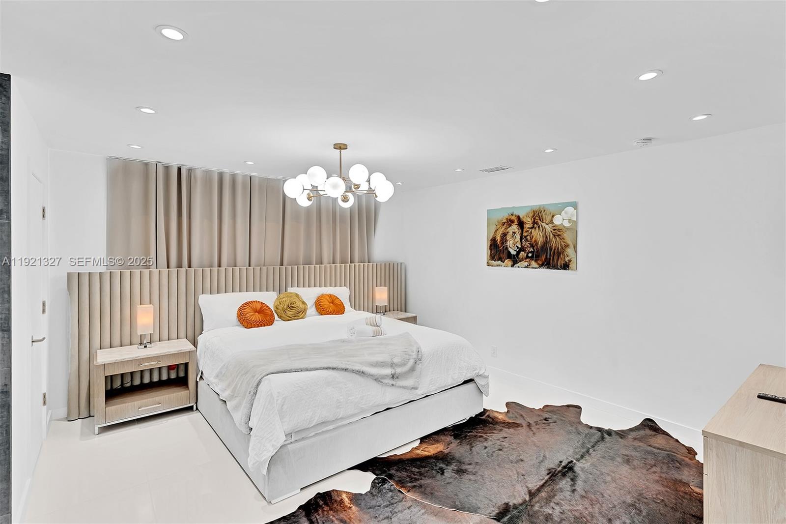 5005 Johnson Street Hollywood, FL 33021 - Photo 16 of 39 a bedroom with a bed and a chandelier