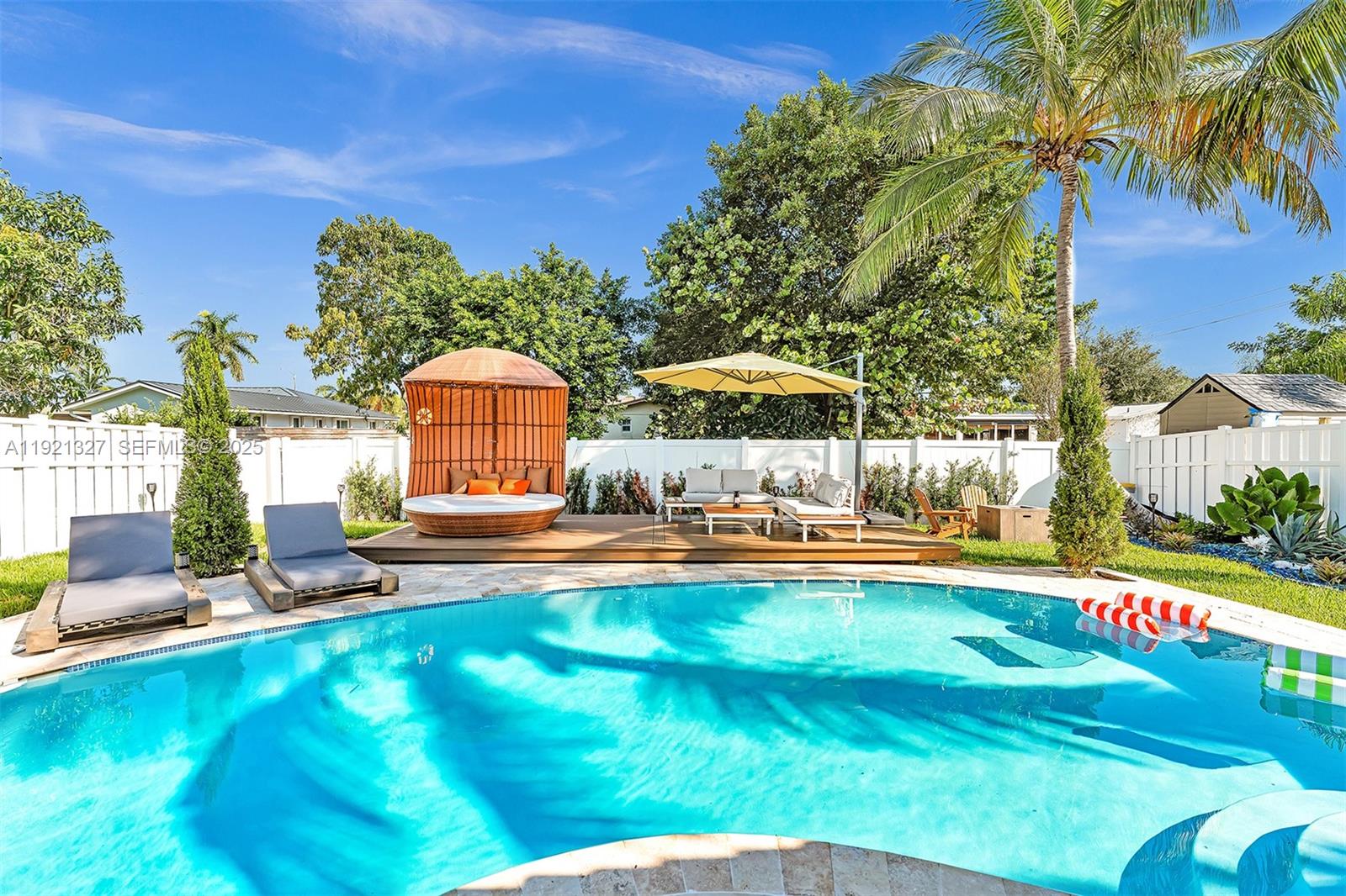 5005 Johnson Street Hollywood, FL 33021 - Photo 27 of 39 a view of a swimming pool with a sitting area