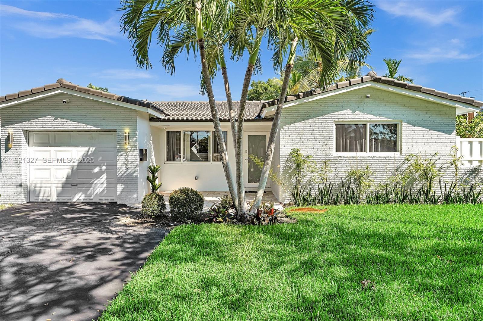 5005 Johnson Street Hollywood, FL 33021 - Photo 38 of 39 a front view of a house with a yard