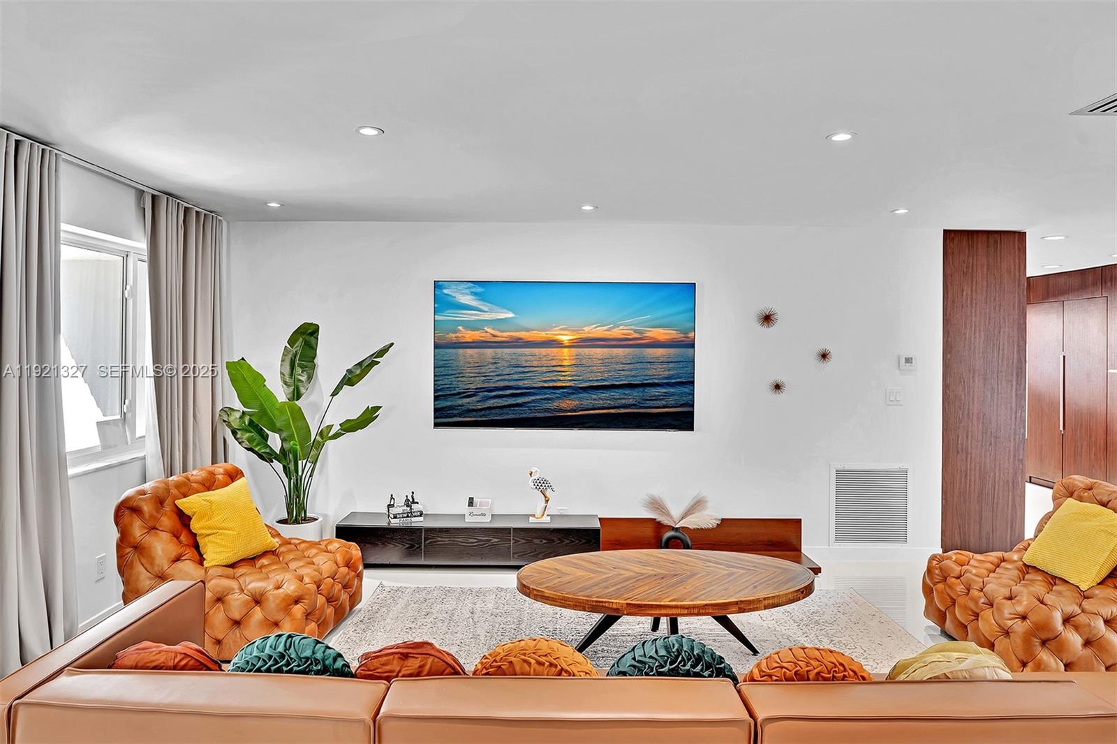 5005 Johnson Street Hollywood, FL 33021 - Photo 4 of 39 a living room with furniture and a flat screen tv