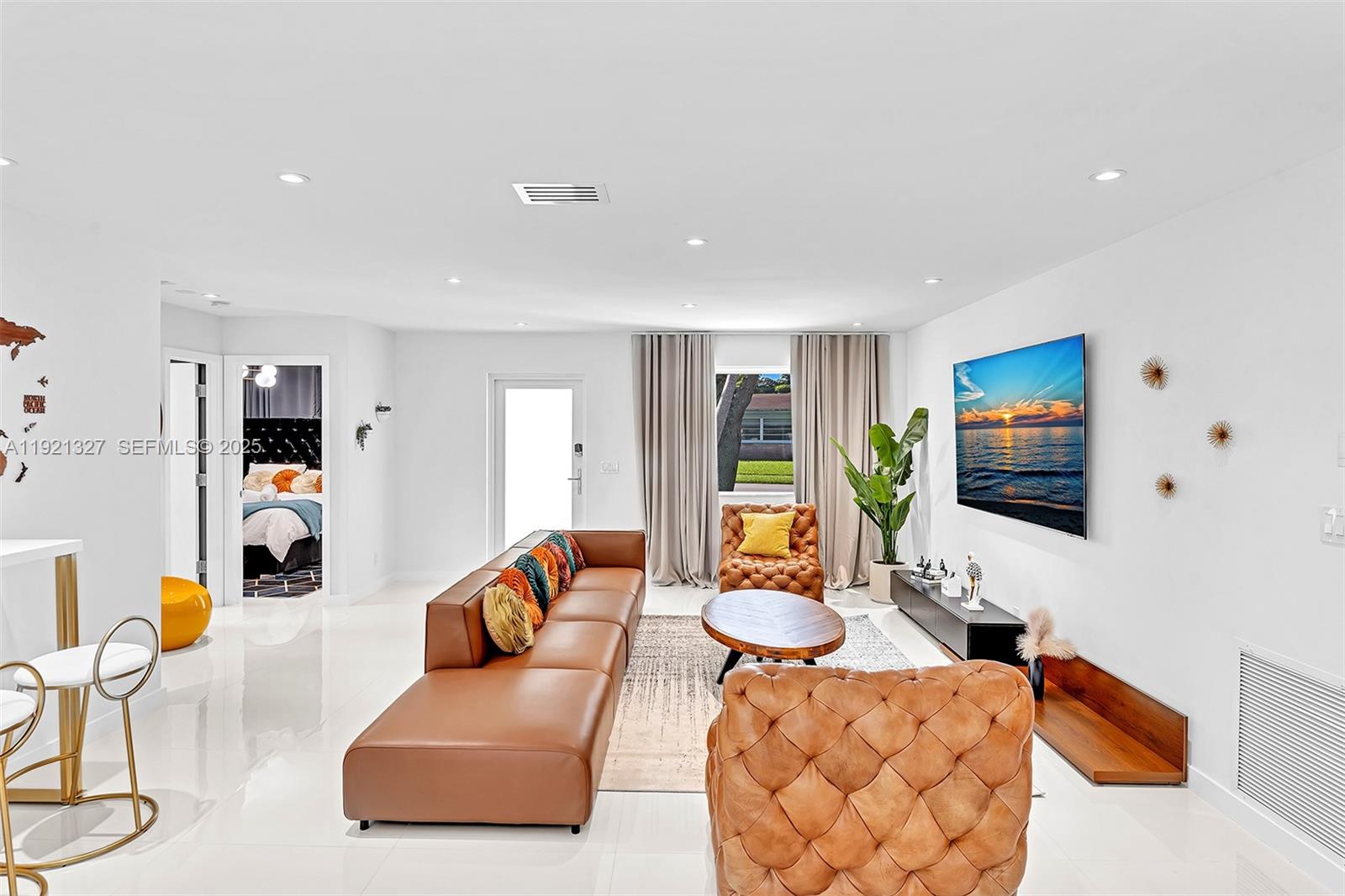 5005 Johnson Street Hollywood, FL 33021 - Photo 7 of 39 a living room with furniture and a flat screen tv