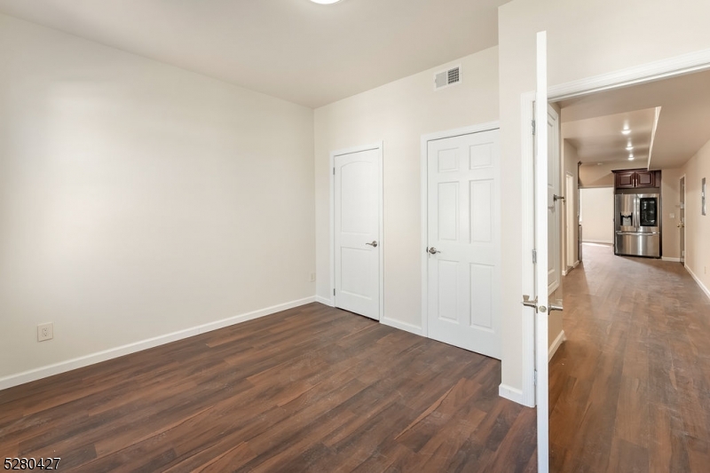 120 Paine Avenue, Unit 2R Irvington, NJ 07111 - Photo 11 of 16 wooden floor in an empty room