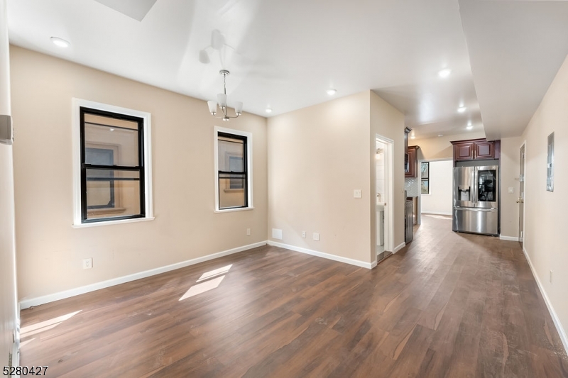 120 Paine Avenue, Unit 2R Irvington, NJ 07111 - Photo 5 of 16 a view of a big room with wooden floor and a kitchen