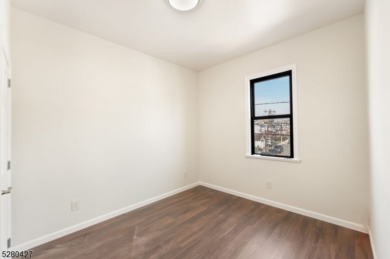 120 Paine Avenue, Unit 2R Irvington, NJ 07111 - Photo 8 of 16 an empty room with a window