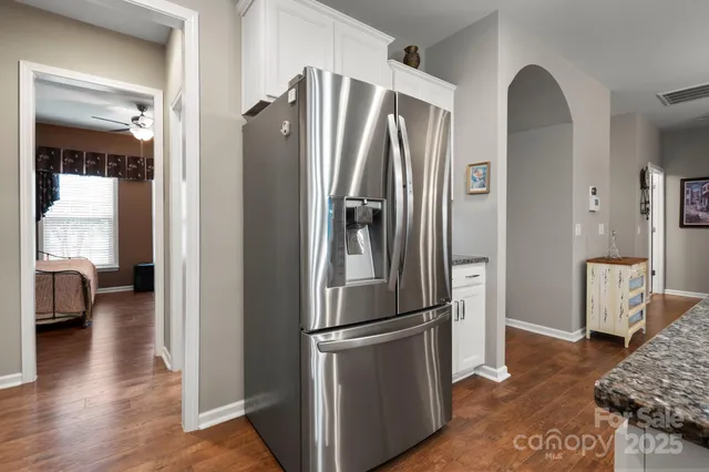 a kitchen with stainless steel appliances granite countertop a refrigerator and a stove