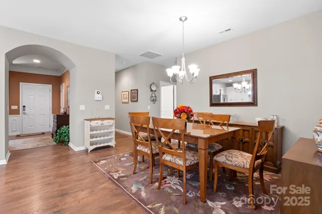 a view of a dining room with furniture and chandelier