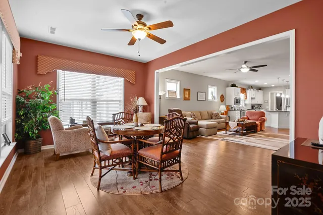 a view of a dining room with furniture window and wooden floor