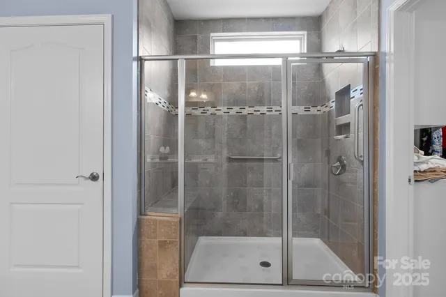 a bathroom with a glass shower door