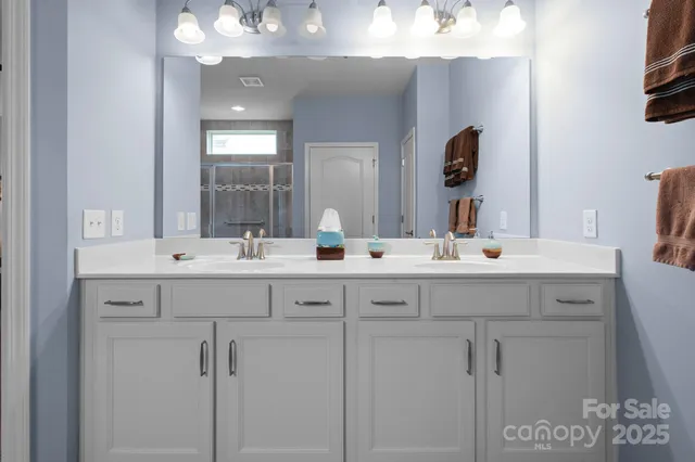 a bathroom with a sink vanity and a mirror