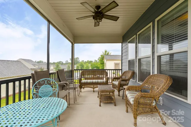 a balcony with furniture and a view of city